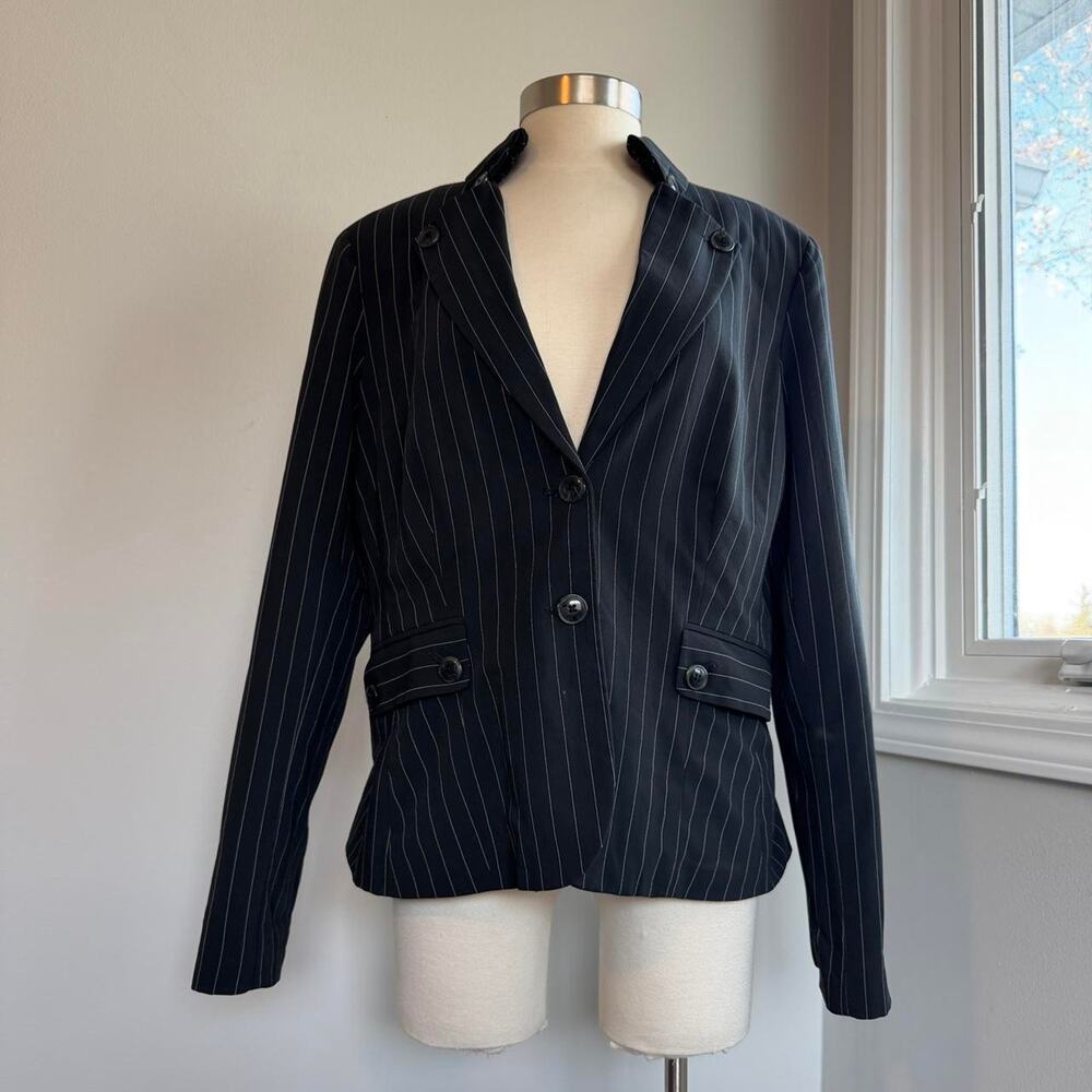 Black pinstripe blazer with lots of buttons and shoulder pads
